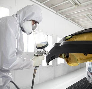 Collision Center Technician Painting a Vehicle | Ed Martin Toyota in Noblesville IN