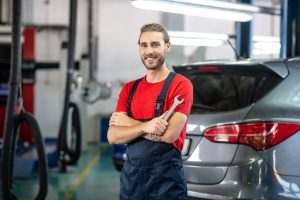 Mechanic working on a vehicle's transmission near Noblesville, IN