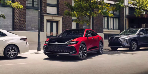 A red and black 2024 Toyota Crown pulling away from a curb near Noblesville, Indiana