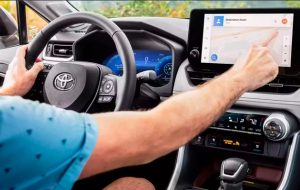 The interior of a 2024 Toyota RAV4, with a person using the front LCD screen near Noblesville, Indiana.