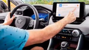 A person operating their informative touchscreen inside their 2024 Toyota RAV4 near Noblesville, Indiana