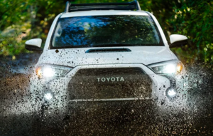 A 2024 Toyota 4Runner driving through mud on a dirt road near Noblesville, Indiana