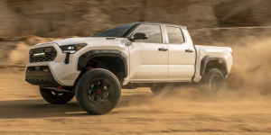 A white 2025 Toyota Tacoma driving through a sandy terrain near Noblesville, Indiana