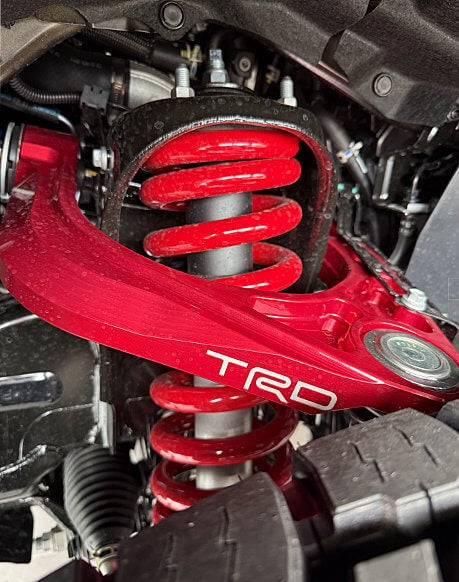 Close up of a TRD suspension lift kit in red