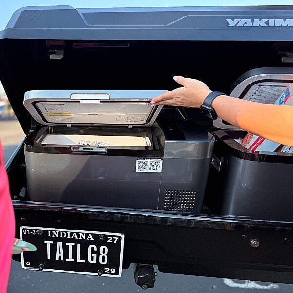 Someone opening the cooler in the 2026 Toyota Sequoia Tailgate Rental Vehicle for Indianapolis Colts Games from Ed Martin Toyota