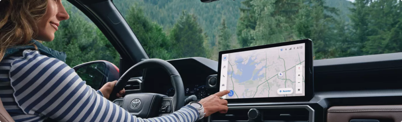 Driver touching a map on a Toyota's center touchscreen