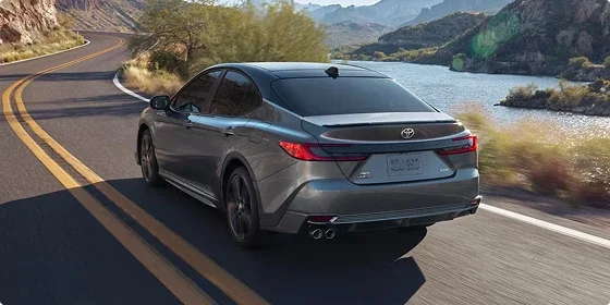 Rear three-quarter view of the 2026 Toyota Camry SE on the road