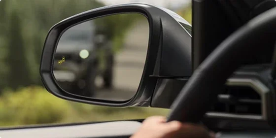 Blind Spot Monitor indicator lit in the side mirror of the 2026 Toyota Tacoma SR5 4x4