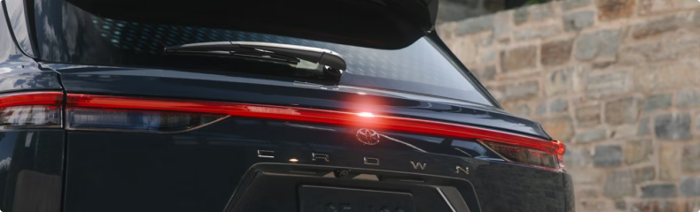 Rear of a dark Crown Signia showing the full-width tail lamp and the Crown lettering