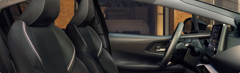Toyota Prius front seats and dashboard seen through the open passenger door