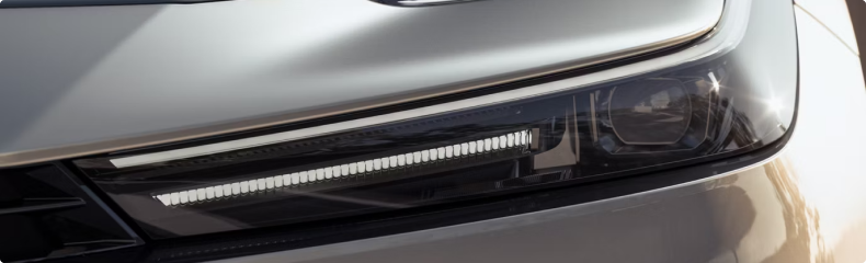 Close-up of a Toyota Prius headlamp and front bumper