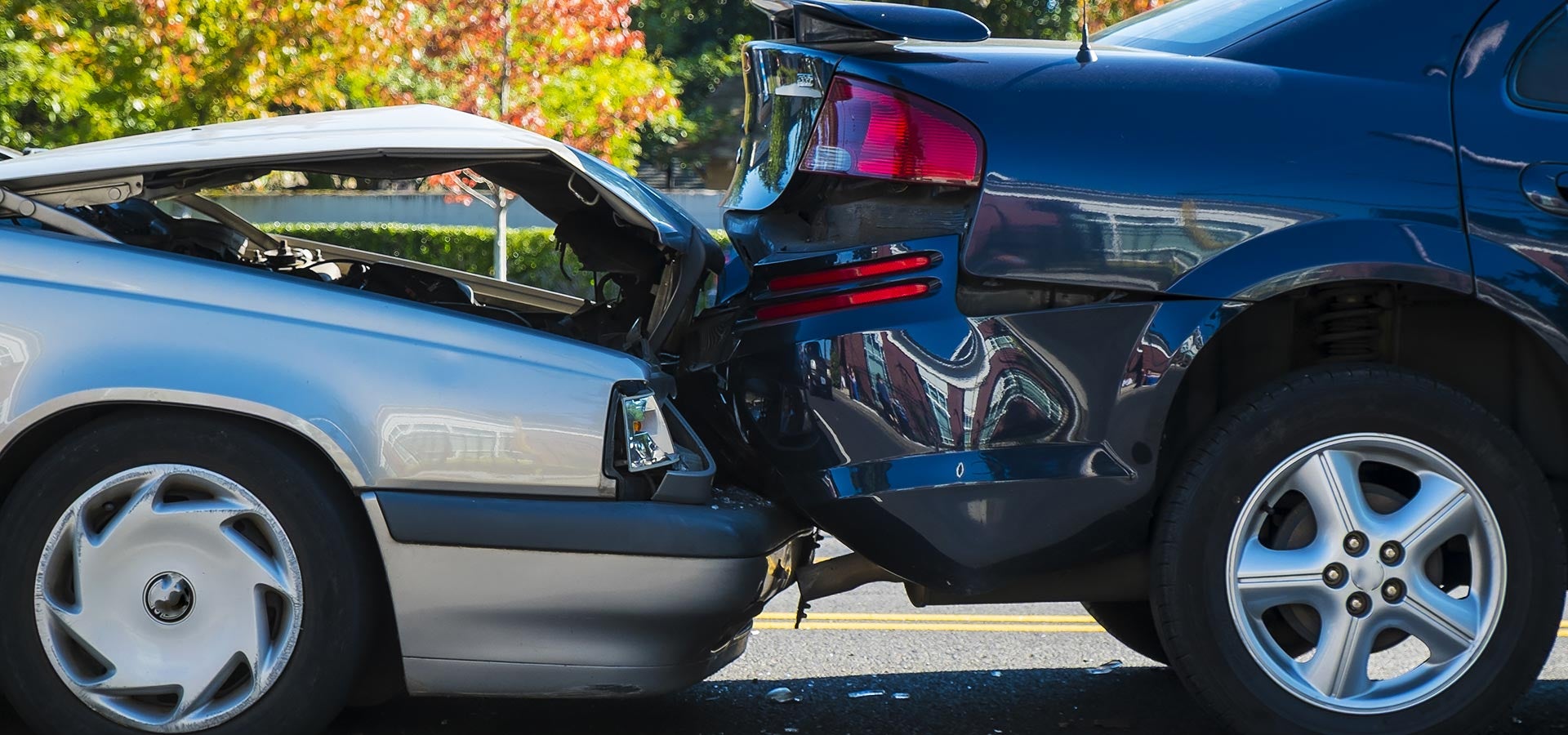 Two vehicles involved in a rear-end collision with visible bumper damage.
